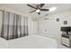 Neutral bedroom with white bedding and ceiling fan at 1007 Lake Avoca Dr, Tarpon Springs, FL 34689