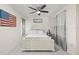 Bright bedroom with neutral walls, white furniture and an American flag on the wall at 1007 Lake Avoca Dr, Tarpon Springs, FL 34689