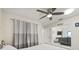 This bedroom boasts a ceiling fan, neutral colored walls and is decorated with modern curtains at 1007 Lake Avoca Dr, Tarpon Springs, FL 34689