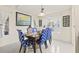 Cozy dining area with blue patterned chairs and a window with natural light at 1007 Lake Avoca Dr, Tarpon Springs, FL 34689