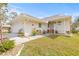 Charming single-story home featuring well-maintained landscaping, a welcoming entrance, and attached garage at 1007 Lake Avoca Dr, Tarpon Springs, FL 34689