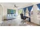 Bright lanai with a blue sofa, desk, tile floors, and windows overlooking the yard at 1007 Lake Avoca Dr, Tarpon Springs, FL 34689