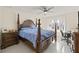 Spacious main bedroom featuring a four poster bed, large windows, and an office area at 1007 Lake Avoca Dr, Tarpon Springs, FL 34689