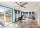 Enclosed sunroom with tile floors, large windows, and a comfortable seating area at 1007 Lake Avoca Dr, Tarpon Springs, FL 34689