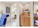 Wet bar with storage cabinets, shelves, and a granite countertop at 1007 Lake Avoca Dr, Tarpon Springs, FL 34689