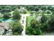 Aerial view of townhomes with mature trees and pond at 102 Brent Cir, Oldsmar, FL 34677
