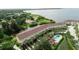Aerial view of waterfront property featuring pool, private docks, and lush landscaping at 102 Brent Cir, Oldsmar, FL 34677