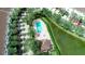 Birds eye view of a waterfront community featuring a pool, hot tub, and lush landscaping at 102 Brent Cir, Oldsmar, FL 34677