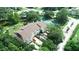 Aerial view of townhomes with parking and mature trees and a pond at 102 Brent Cir, Oldsmar, FL 34677
