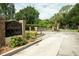 Elegant gated entrance to Seaside Estates featuring lush landscaping and secure access at 102 Brent Cir, Oldsmar, FL 34677