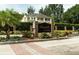 The brick entrance to Seaside Estates has luscious greenery and landscaping on a clear day at 102 Brent Cir, Oldsmar, FL 34677