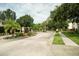 A beautiful brick entrance with manicured plants and flowers leads into the Seaside Estates at 102 Brent Cir, Oldsmar, FL 34677