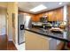 Well-appointed kitchen featuring stainless steel appliances, granite counters, and ample cabinet space at 102 Brent Cir, Oldsmar, FL 34677