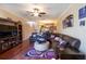 Spacious living room with a large leather sofa, hardwood floors, and elegant decor at 102 Brent Cir, Oldsmar, FL 34677