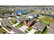 Scenic view of a community with ponds, showcasing a charming two-story home with solar panels at 11804 Bluegrass Field Ct, Riverview, FL 33579