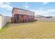Expansive backyard featuring a well-kept lawn, a privacy fence, and a covered patio at 11804 Bluegrass Field Ct, Riverview, FL 33579