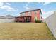 Large backyard featuring a well-maintained lawn, a fence, and an enclosed porch at 11804 Bluegrass Field Ct, Riverview, FL 33579