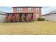 Spacious backyard with a manicured lawn and a covered patio area with curtains for privacy at 11804 Bluegrass Field Ct, Riverview, FL 33579