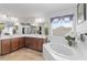 Bathroom featuring a soaking tub, a vanity with countertop space, and a large mirror at 11804 Bluegrass Field Ct, Riverview, FL 33579