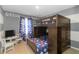 A bedroom is designed with playful decor, featuring a bunk bed and a dedicated study area at 11804 Bluegrass Field Ct, Riverview, FL 33579