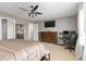 Bedroom with a ceiling fan, dresser, and a computer desk setup near the window at 11804 Bluegrass Field Ct, Riverview, FL 33579
