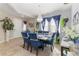 Elegant dining room featuring a modern chandelier, stylish decor, and comfortable seating at 11804 Bluegrass Field Ct, Riverview, FL 33579