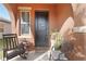 Inviting front porch featuring a comfortable rocking chair and a welcoming entrance at 11804 Bluegrass Field Ct, Riverview, FL 33579