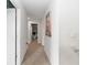 A bright hallway with artwork and a view of a play area featuring a table and chairs at 11804 Bluegrass Field Ct, Riverview, FL 33579