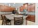 Spacious kitchen featuring granite countertops, stainless appliances, a central island with bar seating, and a mosaic backsplash at 11804 Bluegrass Field Ct, Riverview, FL 33579