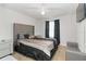 The main bedroom showcases a luxurious upholstered headboard, neutral tones, and ample natural light at 11804 Bluegrass Field Ct, Riverview, FL 33579