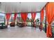 Enclosed patio featuring seating area with orange curtains, offering a relaxing outdoor space at 11804 Bluegrass Field Ct, Riverview, FL 33579