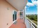 Private balcony offering serene views of the greenery and blue skies above at 4516 Seagull Dr # 303, New Port Richey, FL 34652