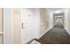Hallway view showcasing neutral tones and well-lit corridor leading to unit 303 at 4516 Seagull Dr # 303, New Port Richey, FL 34652