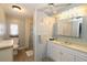 Bathroom featuring a vanity, a walk-in shower with a curtain, and a toilet at 114 W Saint Johns Way, Apollo Beach, FL 33572