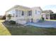Charming home featuring a covered porch, brick foundation, and well-maintained landscaping at 114 W Saint Johns Way, Apollo Beach, FL 33572