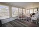 Cozy sun room with lots of windows, wood-look floors, and seating at 114 W Saint Johns Way, Apollo Beach, FL 33572
