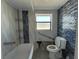 Bathroom with blue accent wall, accessible grab bars, and bathtub at 16333 Gulf Blvd # 105, St Petersburg, FL 33708