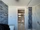 Bathroom doorway with blue accent wall and view to renovated area at 16333 Gulf Blvd # 105, St Petersburg, FL 33708