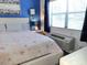 Cozy bedroom with wood-look flooring, starfish bedding, and a window air conditioner at 16333 Gulf Blvd # 105, St Petersburg, FL 33708