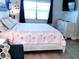 Bright bedroom with wood-look flooring, starfish bedding, and dresser at 16333 Gulf Blvd # 105, St Petersburg, FL 33708