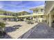Inviting courtyard with outdoor seating and views of yellow condo buildings and the community pool at 16333 Gulf Blvd # 105, St Petersburg, FL 33708