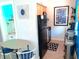 Compact kitchen area with wood cabinets, stainless steel appliances and a dining table at 16333 Gulf Blvd # 105, St Petersburg, FL 33708