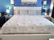 Large main bedroom with starfish bedspread, blue walls and side tables at 16333 Gulf Blvd # 105, St Petersburg, FL 33708