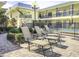 Community pool with multiple lounge chairs for relaxing under the sun at 16333 Gulf Blvd # 105, St Petersburg, FL 33708