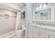 Bathroom showcases a walk-in shower, updated vanity and white cabinetry, with a shower niche at 2546 Oakleaf Ln # 35D, Clearwater, FL 33763