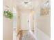 Bright entryway with wood-look flooring, decorative wall accents, and a view into the living space at 2546 Oakleaf Ln # 35D, Clearwater, FL 33763