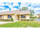 Inviting single-story home featuring a well-maintained lawn, classic windows, and a warm, welcoming facade at 2546 Oakleaf Ln # 35D, Clearwater, FL 33763