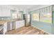 Well-lit kitchen featuring stainless steel appliances, granite countertops, and ample cabinet space for cooking at 2546 Oakleaf Ln # 35D, Clearwater, FL 33763