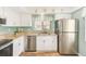 Charming kitchen with stainless steel appliances, white cabinets, and bright, sunny window at 2546 Oakleaf Ln # 35D, Clearwater, FL 33763