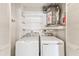 Functional laundry room with washer, dryer, and shelving for storage and organization at 2546 Oakleaf Ln # 35D, Clearwater, FL 33763